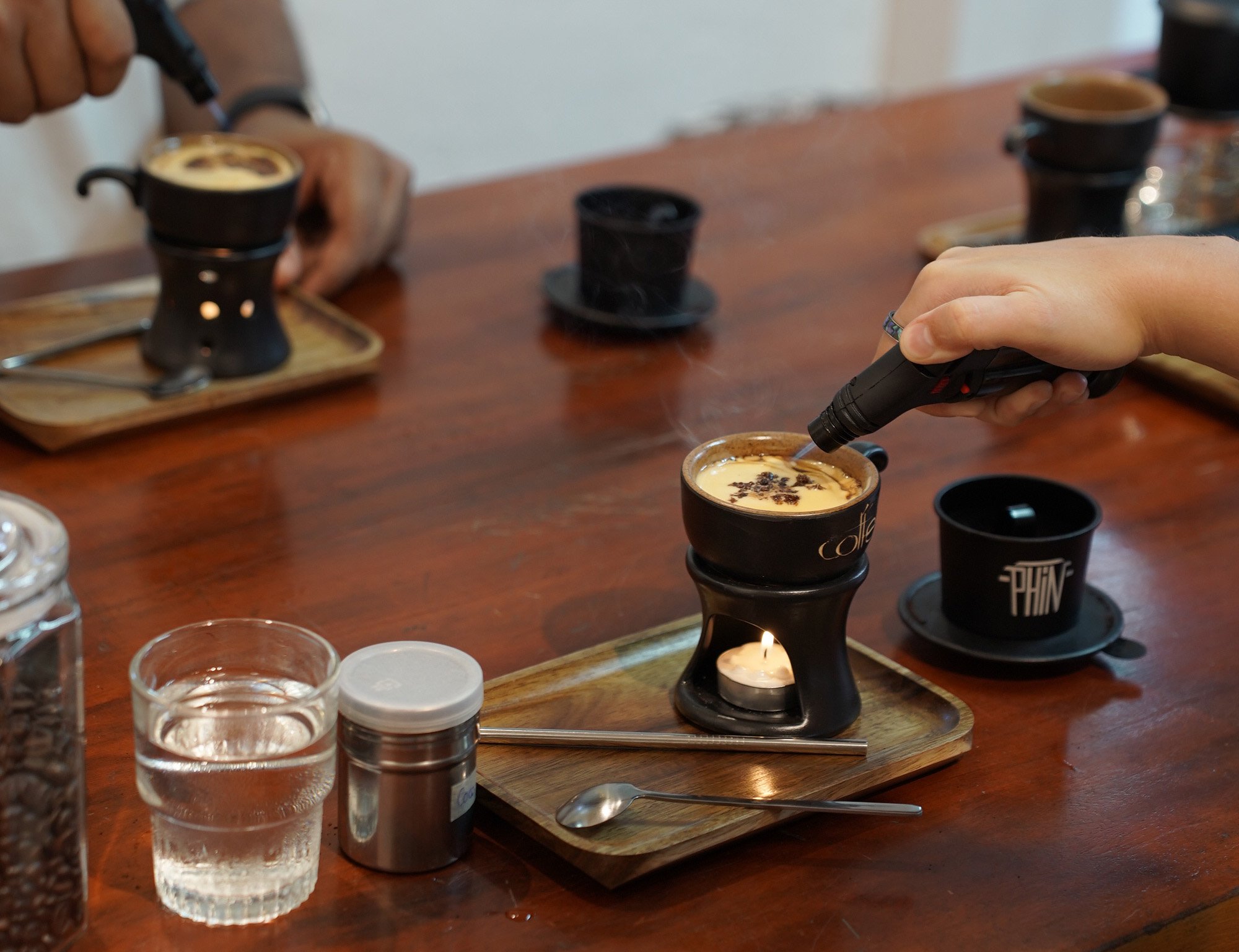 A guest finishing a Vietnamese coffee drink.