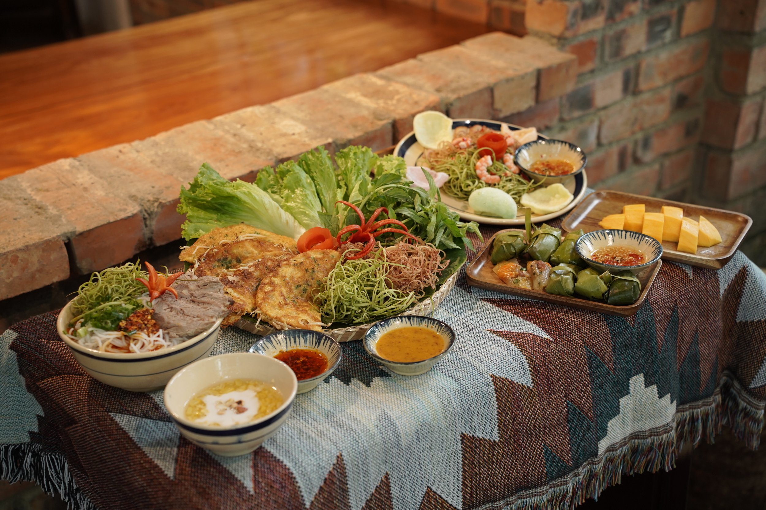 A table set with traditional Huế dishes.